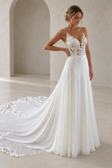Vedress chiffon A-line wedding dress with a plunging V-neck, sheer floral lace bodice, spaghetti straps and a flowing lace-edged train.