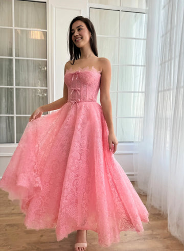 sweetheart lace homecoming dress with bow details, structured corset bodice, and tea-length A-line skirt