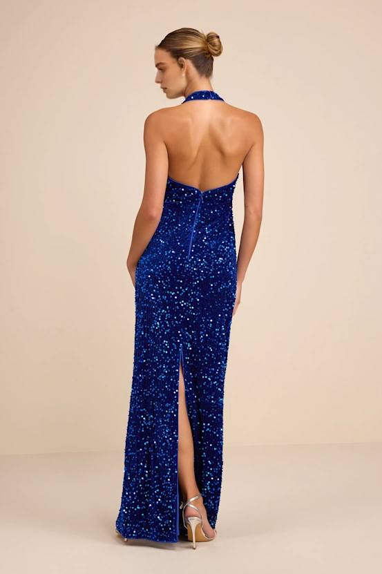 Back view of blue sequin halter formal dress with open back, center zipper closure, back slit, and floor length column fit by VEDRESS