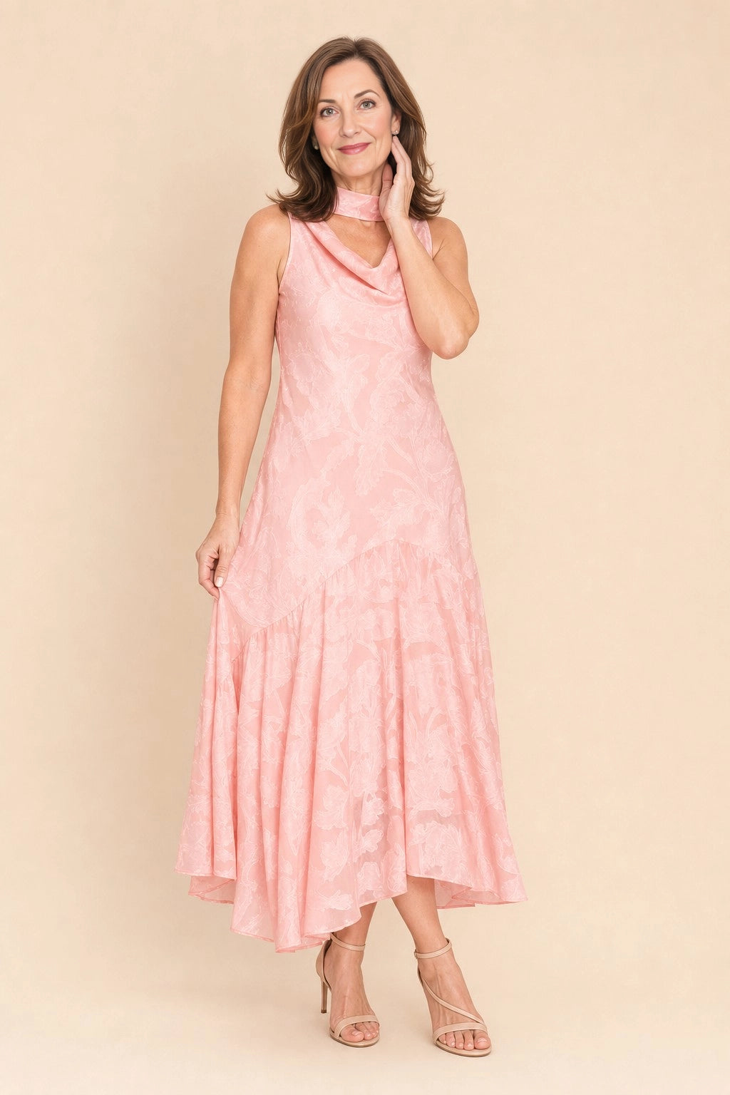 Vedress blush pink jacquard a‑line midi mother of the bride dress,front view sleeveless cowl neck,asymmetrical ruffled hem,textured floral fabric,beige studio background