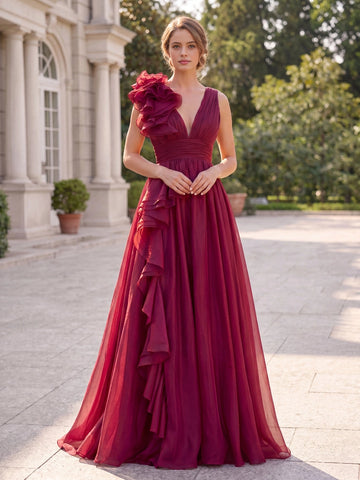 Vedress burgundy prom dress,front view one‑shoulder with large 3D floral ruffle,deep V‑neck,ruched waistband,flowy chiffon A‑line floor skirt,classic manor outdoor background