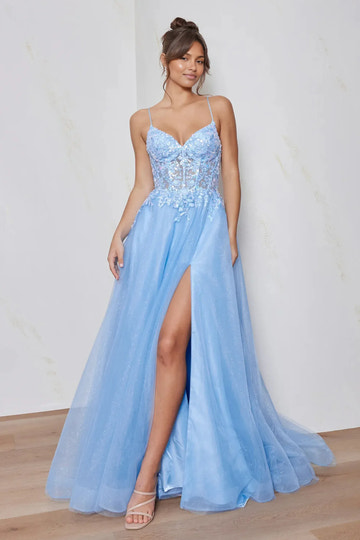 sweetheart A-line floor-length prom gown with sheer corset bodice, floral sequin lace appliques, glitter tulle skirt and side pockets against minimalist studio wall