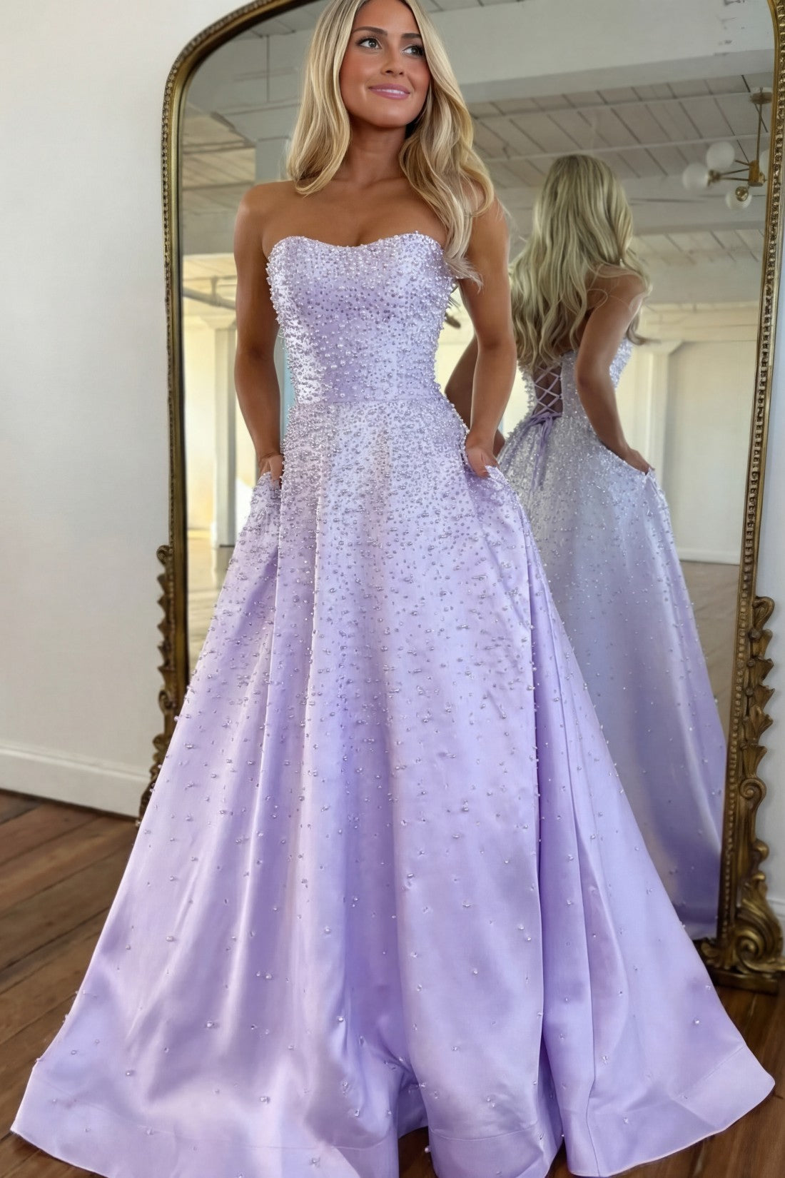 Vestido largo de satén con escote corazón sin tirantes, pedrería y bolsillos laterales, ideal para fiestas de graduación y como invitada de boda
