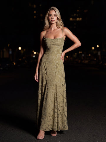 Vedress olive green bridesmaid dress,front view thin spaghetti straps,straight square neckline,3D floral textured fabric,flowy A‑line floor‑length skirt,night city background