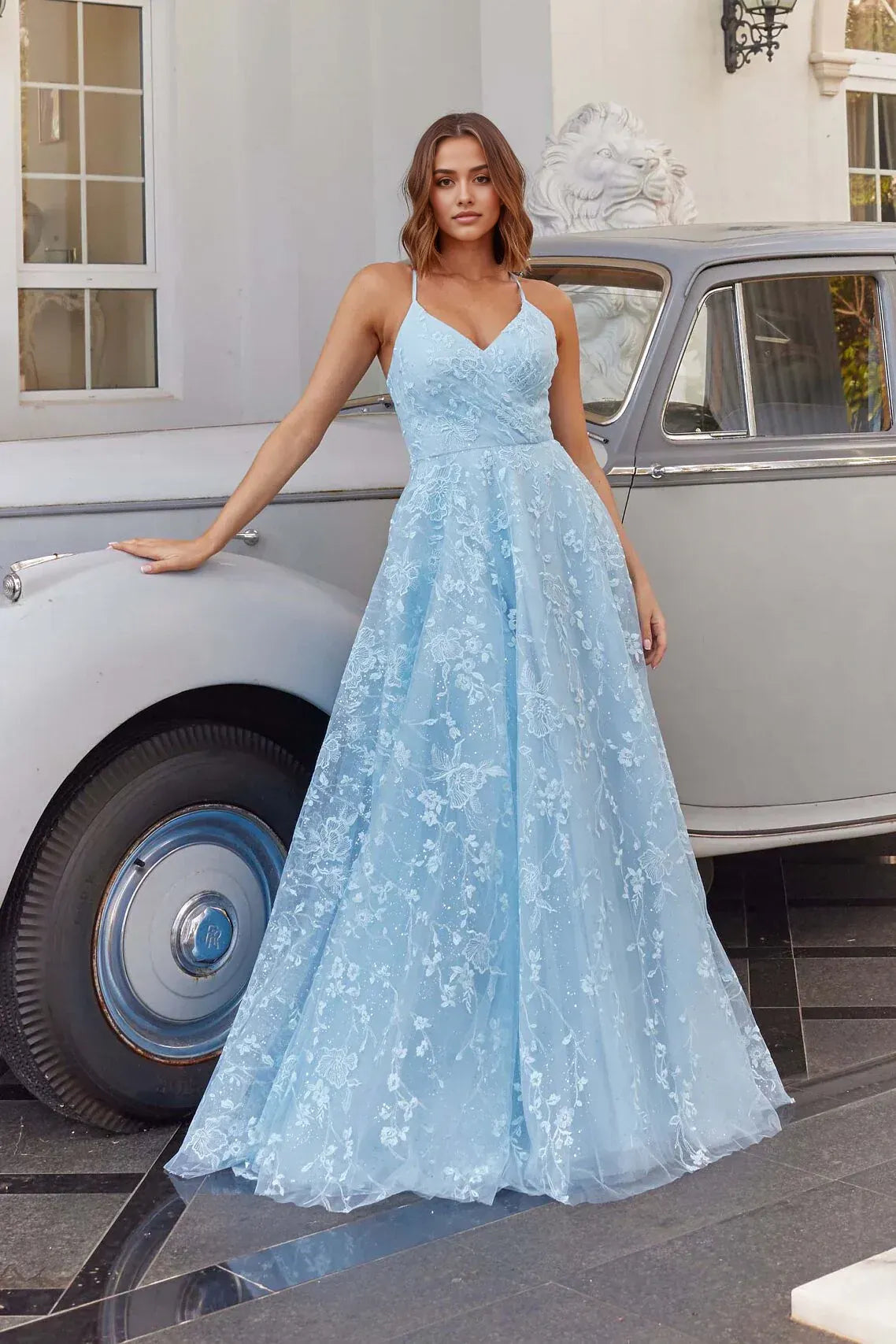 A-line prom dress with V-neckline, floral embroidery, fitted bodice, full tulle skirt, and floor-length hem