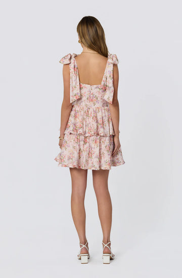 Back view of floral tie-shoulder mini dress with square back, zipper closure, and tiered ruffle skirt for homecoming