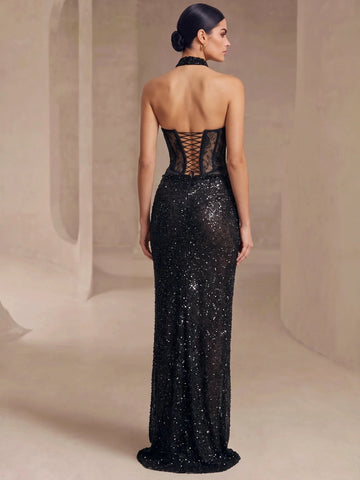 Back view of Vedress black sequin evening dress with an open upper back and crisscross lacing on the sheer lace bodice.