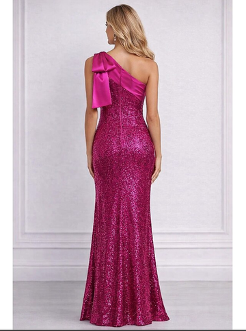 Back view of fuchsia one shoulder sequin prom gown with bow shoulder detail, back zipper closure, fitted sheath silhouette, and floor-length skirt by VEDRESS