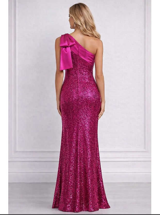 Back view of fuchsia one shoulder sequin prom gown with bow shoulder detail, back zipper closure, fitted sheath silhouette, and floor-length skirt by VEDRESS