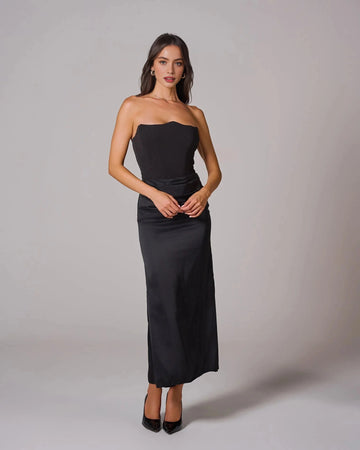 Black strapless wedding guest dress with sculpted bodice and draped waist