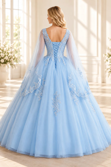 Back view of a Vedress blue prom dress with a scooped lace neckline, ribbon lace-up bodice and sheer lace-trimmed cape panels
