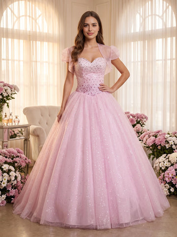 Blush pink floor‑length ball gown prom dress sweetheart heavily beaded bodice removable short puffed‑sleeve tulle shrug criss‑cross lace‑up back full sparkling glitter tulle skirt quinceanera gown by Vedress