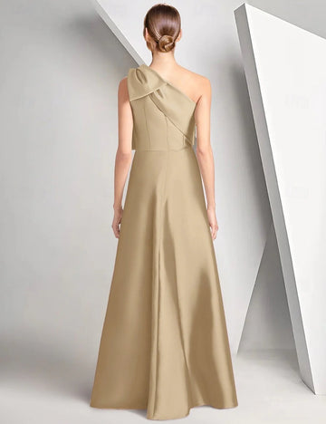 Back view of one-shoulder satin formal gown with shoulder bow, center back closure, and flowing A-line floor-length skirt