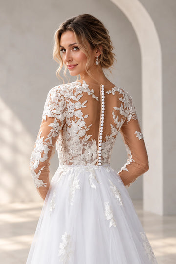 Back detail of Vedress wedding dress showing a sheer illusion back, floral lace appliques and covered buttons from neckline to waist.