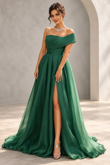 Front view of a Vedress emerald green chiffon prom dress with an asymmetric off-shoulder neckline, pleated bodice and high skirt slit