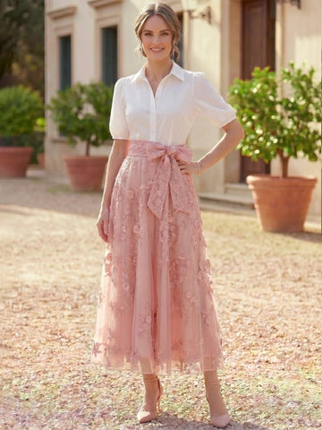 Vedress wedding guest dress with a white collared bodice, short puff sleeves, pink floral lace A-line skirt and side bow waist, front view