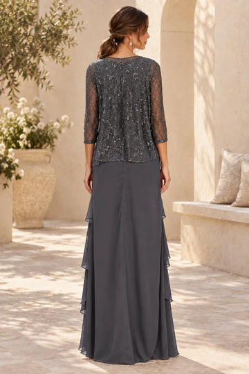 Back view of dark gray mother of the bride dress with sparkling lace overlay, sheer three-quarter sleeves, covered back and flowing layered skirt