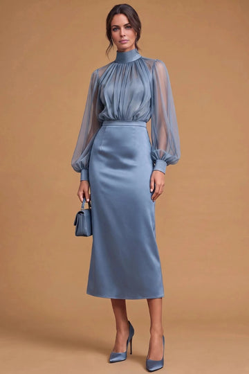 Dusty blue midi wedding guest dress with high gathered neckline, sheer long bishop sleeves, fitted cuffs, defined waist, and sheath skirt by Vedress.