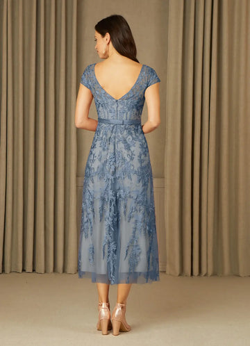 Back view of dusty blue mother of the bride dress featuring a V-back, center zipper, floral embroidery, defined waist, and tea-length A-line skirt.