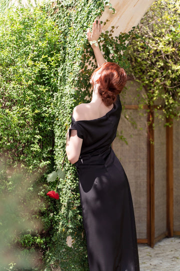 Back view of Vedress off‑shoulder satin sheath evening gown with invisible zipper back