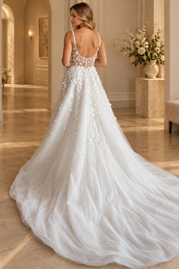 Back view of Vedress wedding dress showing a deep U-shaped low back, sheer floral panels, center-back buttons and flowing train.