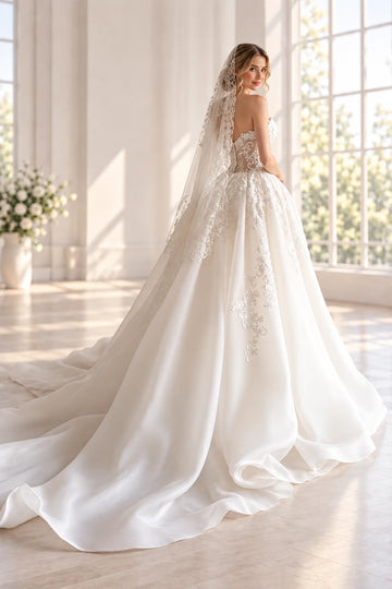 Back view of floral tulle wedding dress with lace-up corset back and long sweeping train