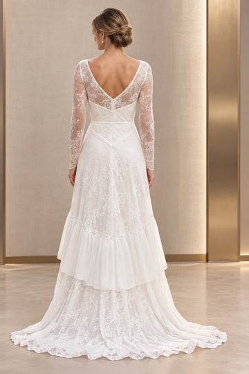 Vedress lace wedding dress with a V-back, sheer lace panels, central zipper, pointed waist trim and ruffled skirt with a train, back view