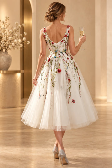 Back view of a Vedress floral embroidered wedding dress with wide shoulder straps, a deep V-back and a full tea-length tulle skirt