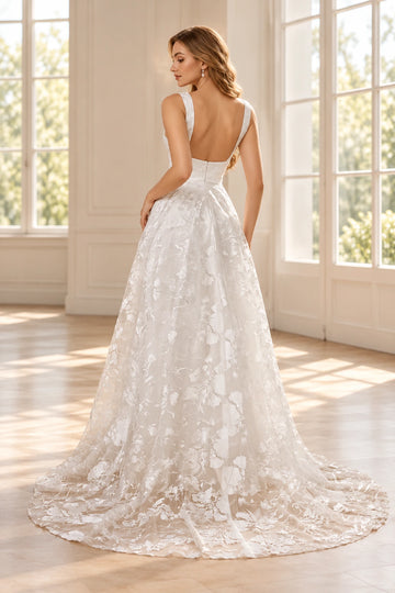 Back view of Vedress floral lace wedding dress featuring a low U-shaped back, center zipper, flowing A-line skirt and sweeping train.