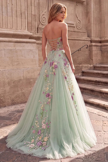Back view of Vedress floral tulle prom dress with an open lace-up back, trailing waist ties and floral details extending onto a sweep train.