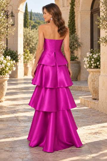 Fuchsia mother of the bride gown featuring straight strapless back, center zipper closure, fitted bodice and dramatic tiered satin-look floor-length skirt, back view.