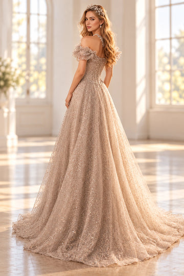 Back view of a Vedress champagne glitter tulle prom dress with a low button-detail back, corset-style bodice and a flowing train