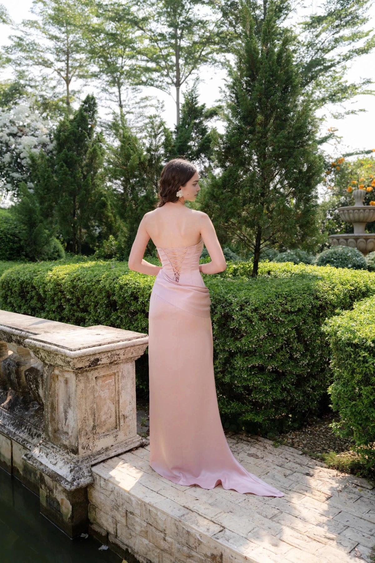 Back view of Vedress lace‑up corset back satin bridesmaid gown with sweep train