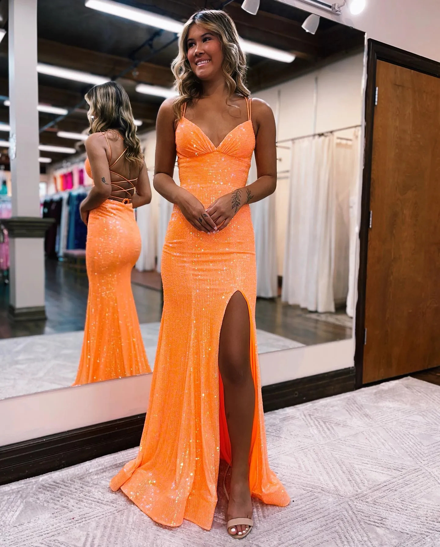 spaghetti strap sequin prom gown with a plunging neckline, fitted sheath silhouette, and high slit