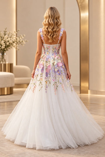 Back view of a Vedress ivory floral wedding dress with flower-trimmed straps, a sheer zipper-back bodice and pastel appliqués cascading onto the tulle skirt.