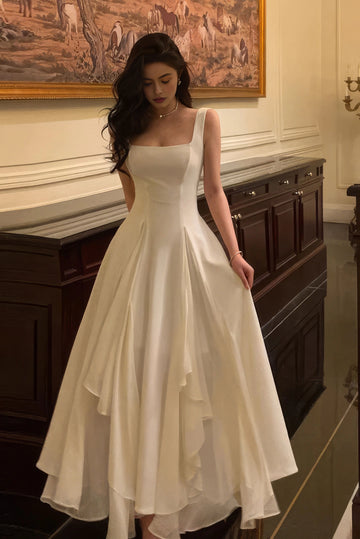 Ivory A-line wedding dress with square neckline, fitted bodice and layered flowing skirt by Vedress