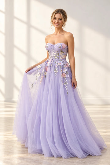 Front view of a Vedress lavender floral tulle prom dress with a strapless sweetheart bodice, bow waist tie and floor-length A-line skirt.