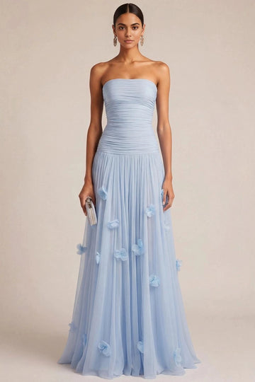 Light blue A-line bridesmaid dress with straight strapless neckline, ruched dropped-waist bodice, scattered 3D flowers, and flowing floor-length skirt by Vedress.