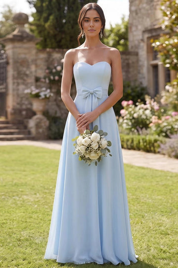 Light blue A-line bridesmaid dress with strapless sweetheart neckline, fitted bodice, decorative waist bow, and flowing floor-length skirt by Vedress.