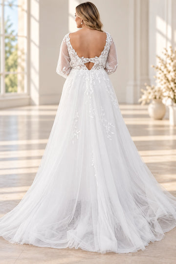 Back view of Vedress tulle wedding dress with a low scoop back, lace connecting band, triangular cutout and flowing train.