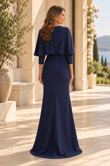 Back view of navy blue mother of the bride gown with a closed cape-covered back, gathered twist waist, three-quarter sleeves and long sheath skirt.