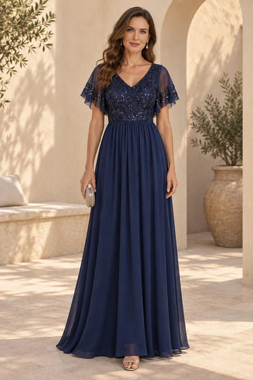 Navy blue A-line mother of the bride dress with V-neckline, sequined floral lace bodice, sheer flutter sleeves and flowing floor-length skirt