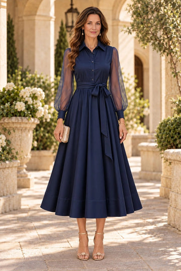Navy blue A-line mother of the bride midi dress with shirt collar, button-front bodice, sheer long bishop sleeves, self-tie waist and flowing skirt.