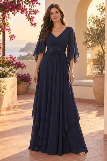 Navy blue A-line mother of the bride dress with V-neckline, sheer flutter sleeves, embellished lace waist and layered floor-length skirt