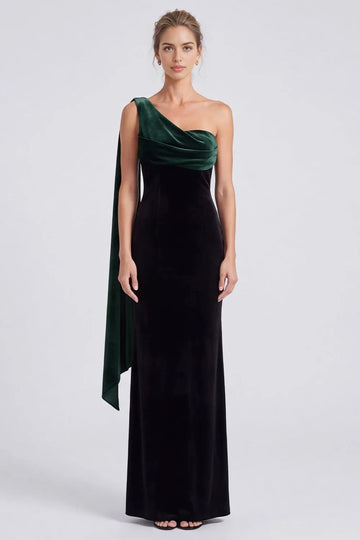 Vedress black velvet sheath evening dress with a contrasting emerald green draped one-shoulder neckline and floor-length skirt.