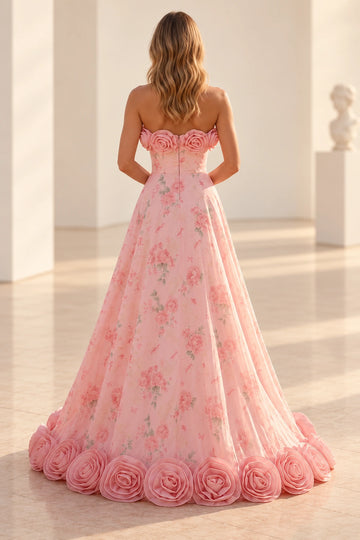 Back view of a Vedress pink rose-print prom dress with a strapless zipper-back bodice and dimensional fabric roses around the neckline and hem.