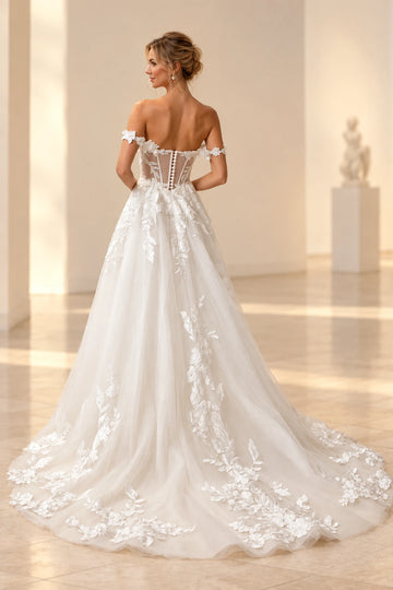 Back view of Vedress wedding dress with a low illusion back, visible boning details, covered buttons and a floral appliqué train.