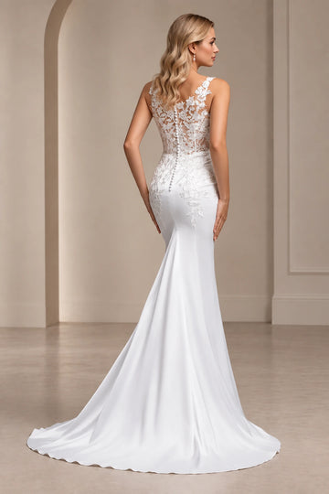 Back view of Vedress mermaid wedding dress with sheer floral lace, covered buttons below the waist and a flowing train.