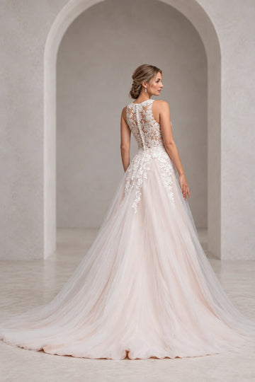 Back view of Vedress wedding dress with high illusion floral lace, covered buttons to the waist and appliqués cascading onto a flowing train.