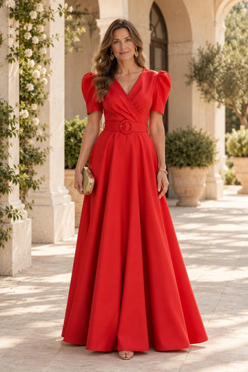 Red A-line mother of the bride dress featuring a wrap-style V-neckline, short puff sleeves, matching round buckle belt and flowing floor-length skirt.